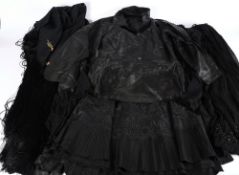 Two black silk overskirts, a black silk petticoat, blouse, shawl,