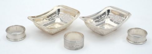Three silver napkin rings, various makers and dates: together with two rectangular bon bon dishes,