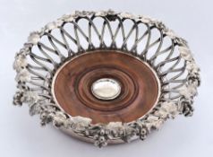 A late Victorian plated wine coaster: of circular form with wire work sides and rim of grape and