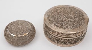 An Indian silver circular trinket box and cover: with trailing foliate decoration, 9cm.