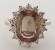 An andalusite and diamond cushion-shaped cluster ring: with central cushion-shaped andalusite