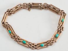 A gold and turquoise mounted three bar gate-link bracelet:, each link with a single, oval turquoise.
