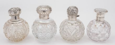 Four clear glass and silver mounted scent bottles: various makers and dates.