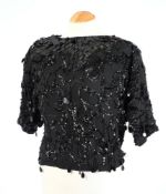 A black sequin short top together with a yellow beadwork and silk top,