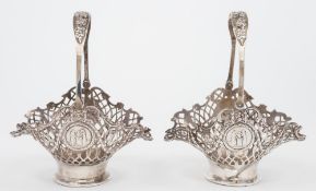 A pair of Edward VII silver swing handle bon bon baskets:, maker William Comyns, London,