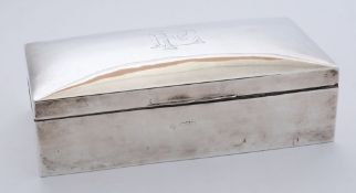 A George V period silver cigarette box, all marks worn: initialled, 18cm. wide.