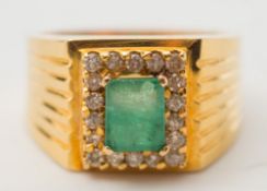 A gentleman's yellow metal, emerald and diamond rectangular cluster ring:,