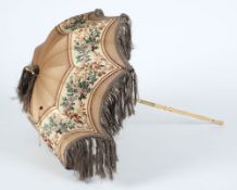 A late Victorian silk fringed parasol: with turned wood handle.