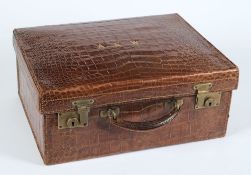 A crocodile skin suitcase:,  initialled A.E.W, 47 x 36cm.