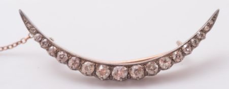 A diamond crescent brooch:, with graduated circular,