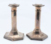 A pair of silver candlesticks, all marks worn: of hexagonal outline on weighted bases, 17cm. high.