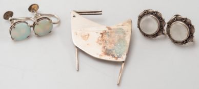 A pair of moonstone earrings, a pair of opal earrings and a modern silver brooch:.