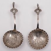 Two continental silver spoons: the embossed bowls decorated with rustic scenes,