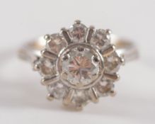 A diamond mounted circular cluster ring: with central, brilliant-cut diamond approximately 0.
