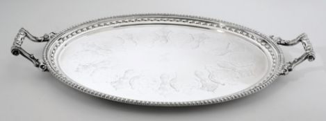 A late Victorian plated oval serving tray: crested, with husk and beaded border,