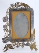 A late 19th century metal and gilt decorated photograph frame: of arched outline with butterfly and