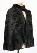 An early 20th century black silk and beaded cape together with eight other various black outfits