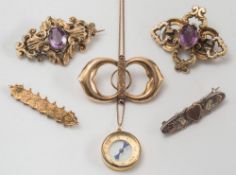 Four gold and gold plated brooches, a silver sweetheart brooch and a compass pendant on chain:.