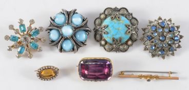 A gold mounted rectangular amethyst brooch, an oval citrine and seed pearl surround brooch,