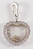 A diamond mounted heart-shaped pendant: with central glazed panel inset with seven floating