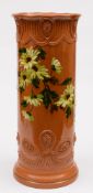 A Burmantofts pottery stick stand: of moulded cylindrical form impasto decorated with daisy-like