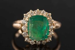 A gold, emerald and diamond cushion shaped cluster ring:,