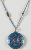 A blue enamelled silver and marcasite-set circular locket: on enamelled chain.