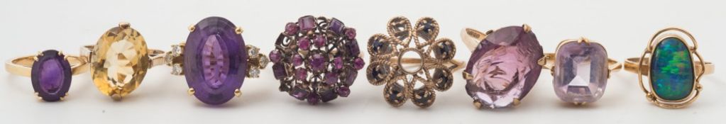 An oval amethyst and diamond dress ring, a ruby-set circular cluster ring,