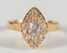 A diamond mounted marquise-shaped cluster ring: with round oval brilliant-cut diamonds,