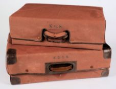 Two brown brushed suede suitcases:, each with canvas cover, largest 64 x 44cm.