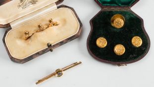 A cased set of foliate engraved dress studs, three gold dress studs and a three stone bar brooch:.