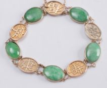 A gold and jade oval panel-link bracelet with character marks:.