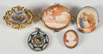 An oval shell cameo brooch depicting chariot and Cupid,
