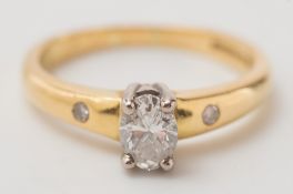 An 18ct gold and four-claw set, oval diamond single stone ring:.