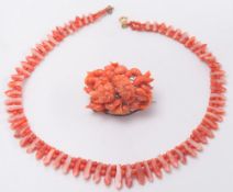 A graduated coral fringe necklace and a carved coral brooch of floral design:.