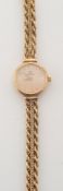 Omega. A lady's 9ct gold mesh-link wristwatch:, the satin-finish circular dial with Roman numerals