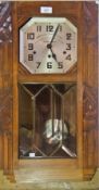 Carved oak wall clock inscribed 