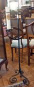 A cast iron candle stand with candle, 12