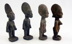 Two pairs of carved wooden Nigerian male