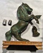 A bronzed metal model of a horse with a