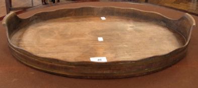 An old brass-bound oval tray with wavy e
