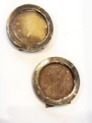 A pair of small silver circular frames,
