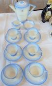 A Shelley Art Deco style china coffee service comprising six cups and saucers, a cream jug, sugar