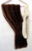 A mink stole together with a cream mink