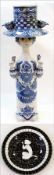 Scandinavian faience model of girl wearing top hat holding tulips, white ground with blue floral