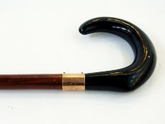 A vintage walking stick with gold plated
