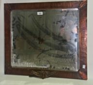 A brass framed mirror with foliate decor