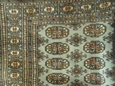 A Tekke design wool rug, the pale blue f