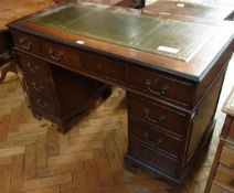 A reproduction mahogany pedestal desk wi