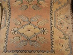 Turkish wool rug, peach ground with styl